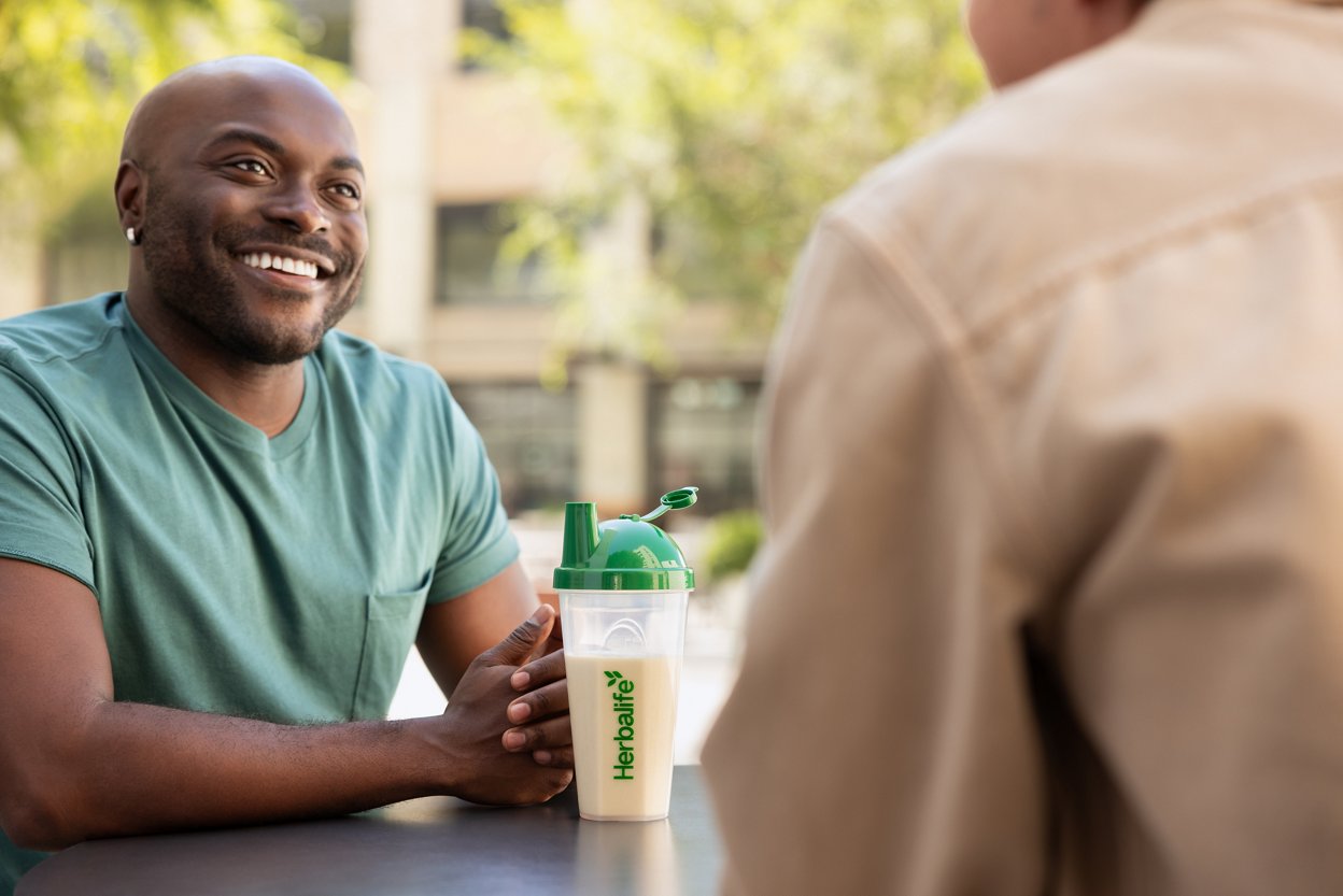 Smiling man sitting with F1 Shake